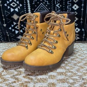 Boots, tan in color. Looks like timberland shoes